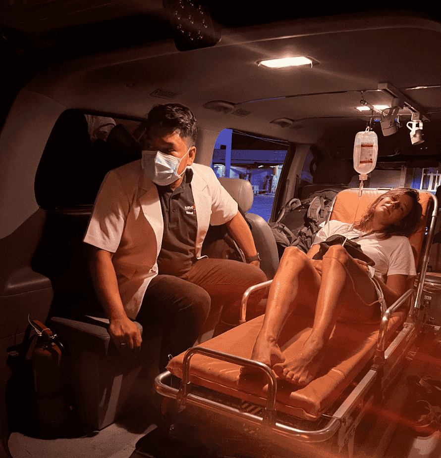 Medical professional providing care inside ambulance